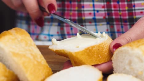 female hands smear butter on bread