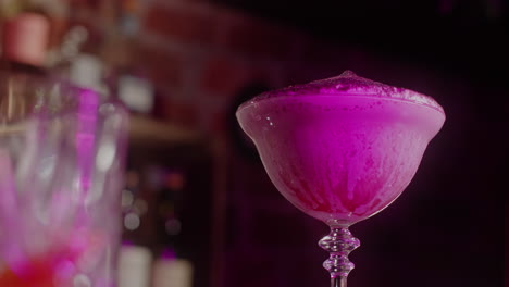 purple cocktail at a nightclub