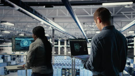software developer in data center checks ai dashboard using laptop