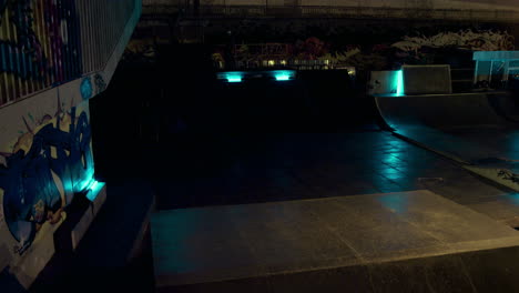 sporty man doing dangerous trick on bmx bike at night urban skate park.