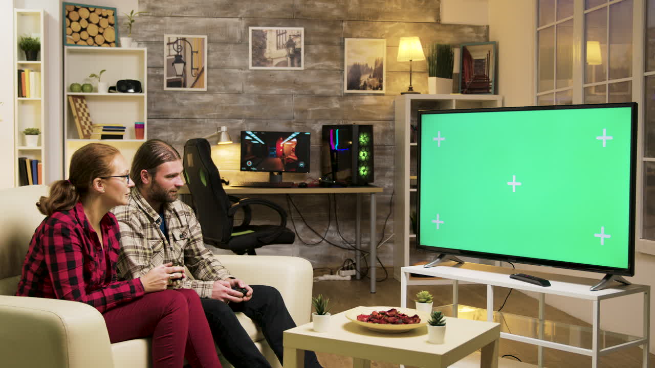 Couple Playing Video Games on Green Screen TV in Living Room