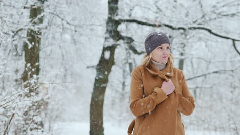 stylish middle-aged woman walks in snow park