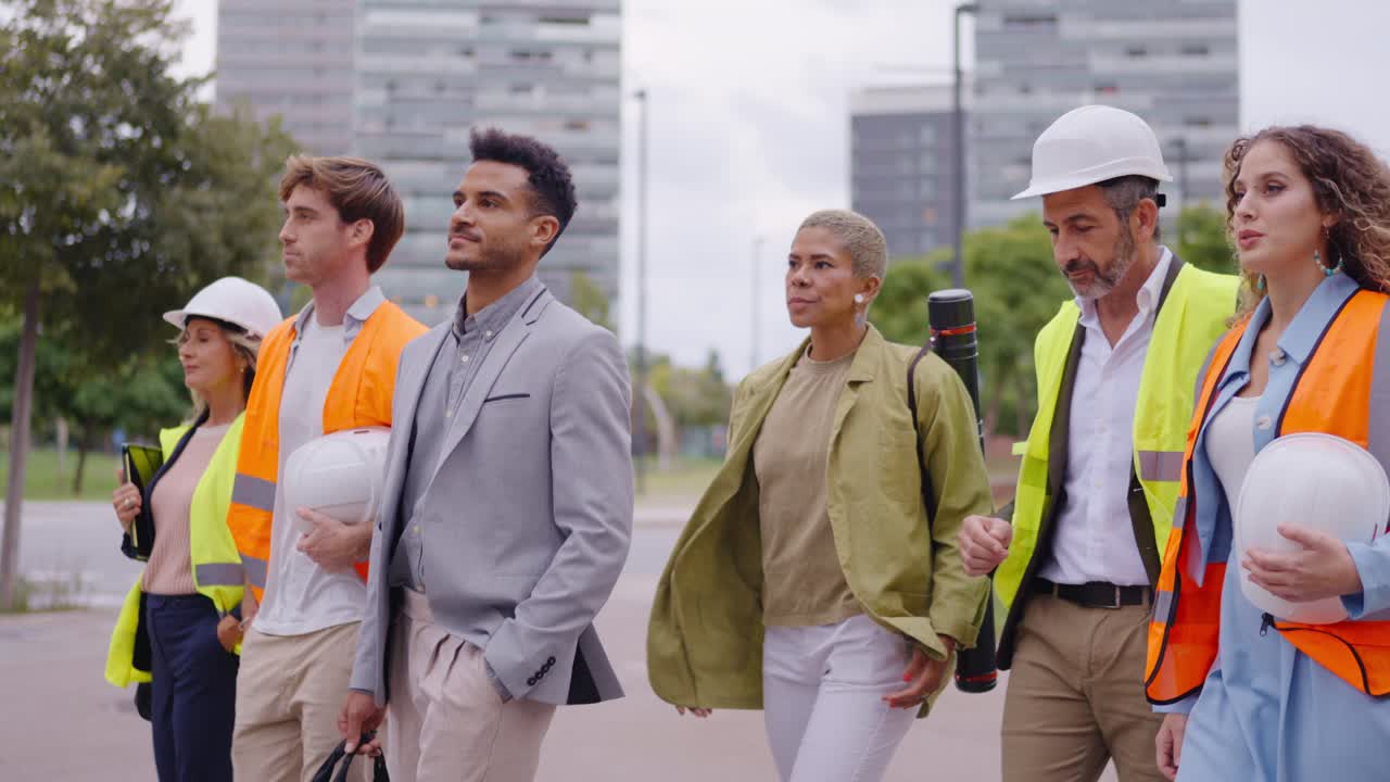 Diverse group of construction workers and professionals walking together in an urban setting
