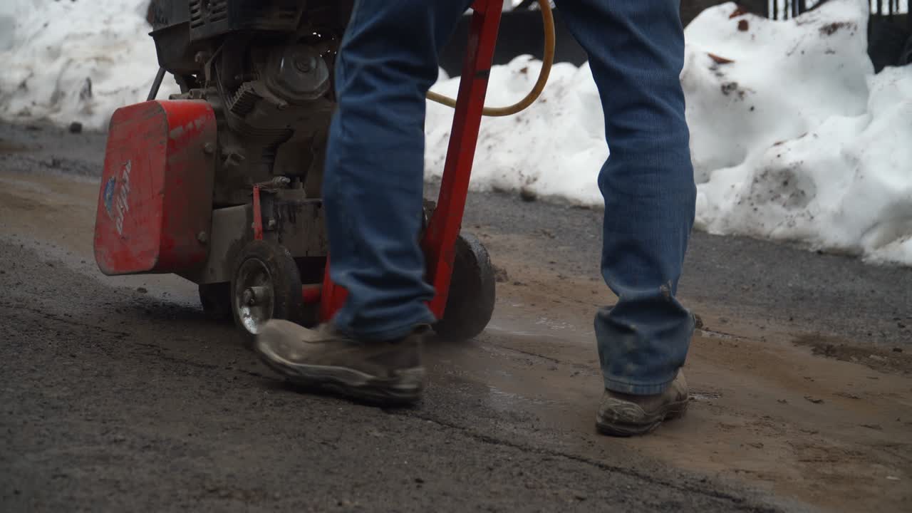 machine cutting the asphalt of a road