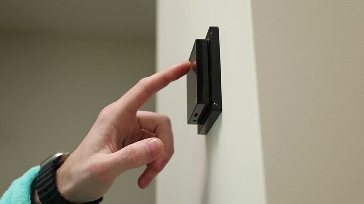 Person interacting with a smart thermostat