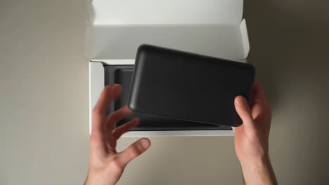 hands unboxing a new electronic device
