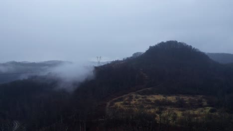 drone hyper lapse of coal power station behind a forest covered hill