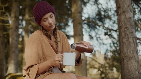 young woman pouring water in mug