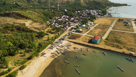 Local-fishing-boats-in-Teluk-port-in-Indonesia,-aerial-drone-view