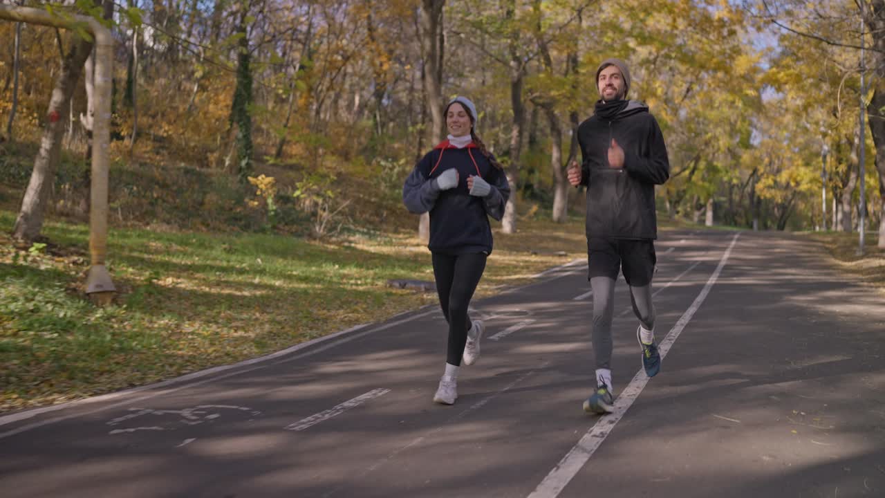 Couple Running in Autumn Park