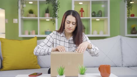 The-young-woman-who-opens-a-parcel-of-gifts-is-happy.