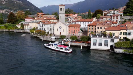 AERIAL---View-of-a-Boat-at-a-Pier-in-Torno,-Lake-Como