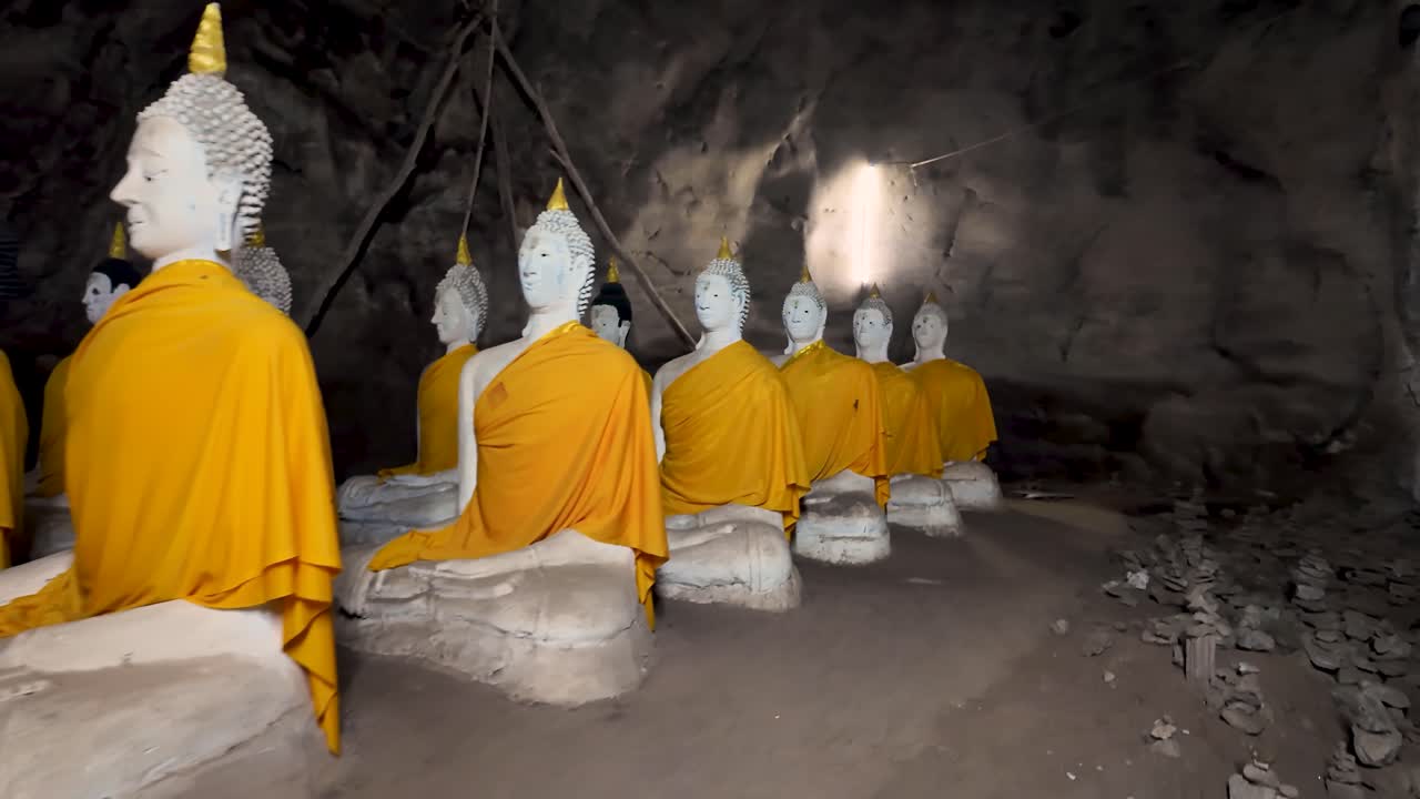 inside Reclining Budda cave sanctuary near Wat Ao Noi temple in the south of thailand. This long cave has various buddhist relics and in on the coast