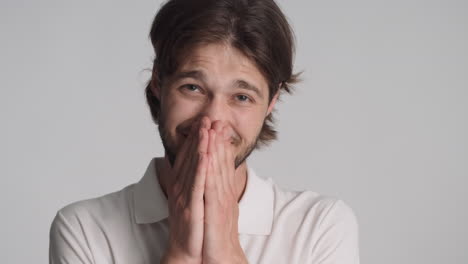 caucasian man in front of camera on gray background.