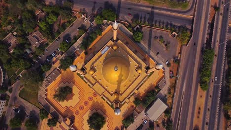 top down aerial of the abuja national mosque with a golden dome and tall minarets in the capital city of nigeria, africa