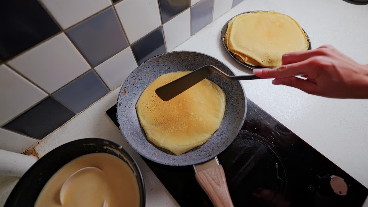 Slow motion cooking moment reveals simple pancake process and warm home feeling