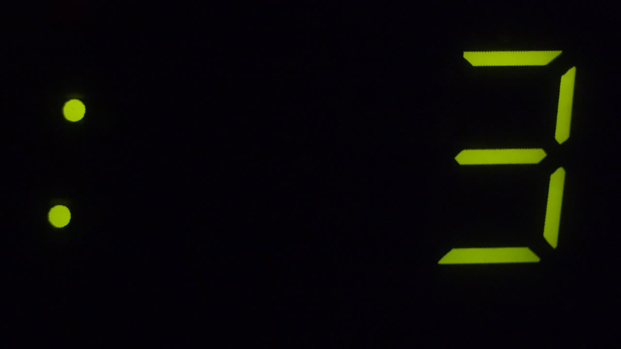 Macro shot of a microwave oven clock counting down