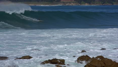 Surfer-Riding-big-waves-on-Carmel-Beach-Pebble