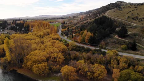 Van-driving-on-New-Zealand-road-during-colourful-autumn