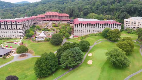 4k drone video of convention center, spa and golf course at historic grove park inn in asheville, nc on sunny summer day-4