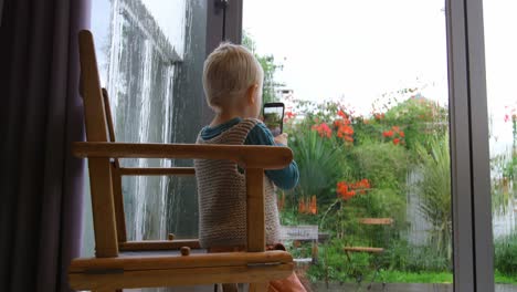 cute boy capturing photo from mobile phone 4k