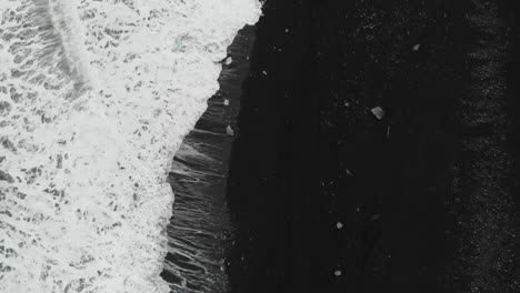 Birdseye-Aerial-View-of-Sea-Waves-Breaking-on-Black-Sand-Beach-on-Iceland-Coast