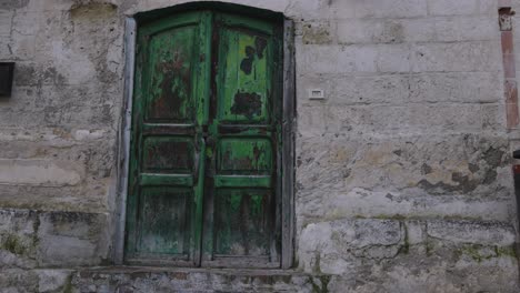 matera, italy green door and wall