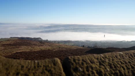 industry chimney through fog clouds passing countryside valley stone tower viewpoint dolly right