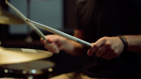 Unrecognizable-drummer-playing-on-drum-kit-in-studio.-Musician-performing-solo