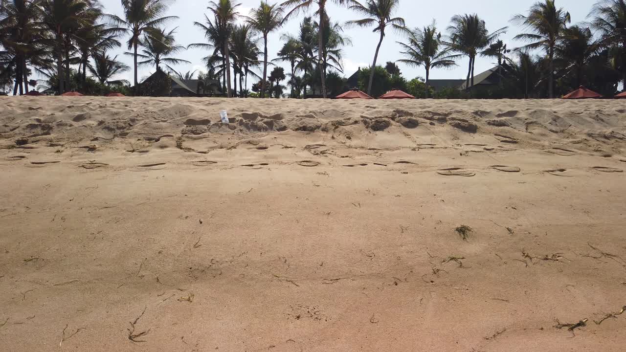 Walking around sandy beach in tropical Indonesia beach. Yellow wild beach with no peoples