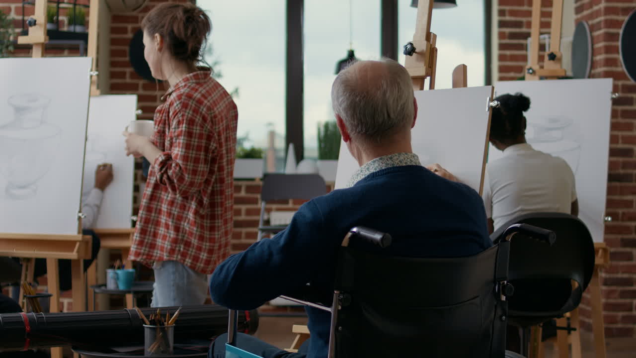 Old man with disability using pencil to draw masterpiece