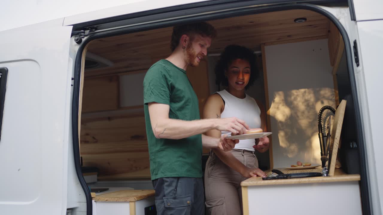 Couple cooking in a campervan