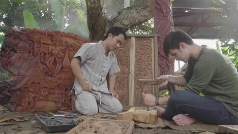 young man learning to carve wooden , slow motion