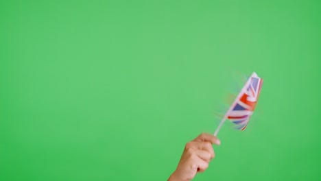 Hand waving a pennant of a british national flag