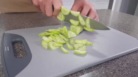 chopping board with cucumber being chopped