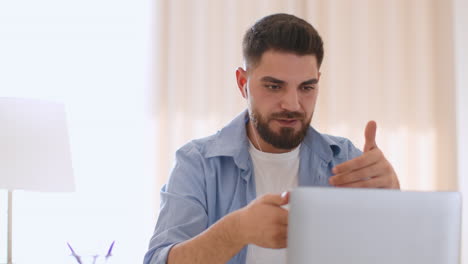 young man having a video call on his laptop