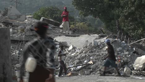 people sift through the rubble following the haiti earthquake