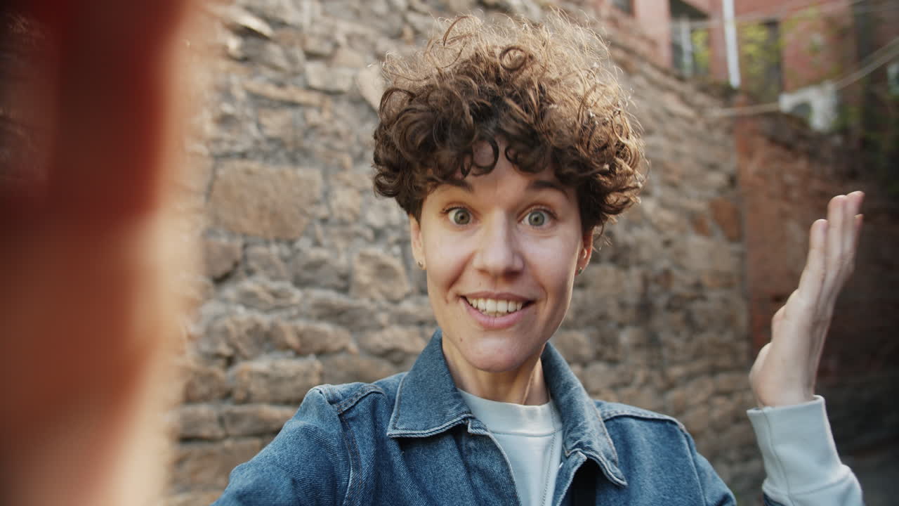 Woman Taking a Selfie in a City Alley