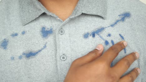 close up of a grey shirt with blue ink stains