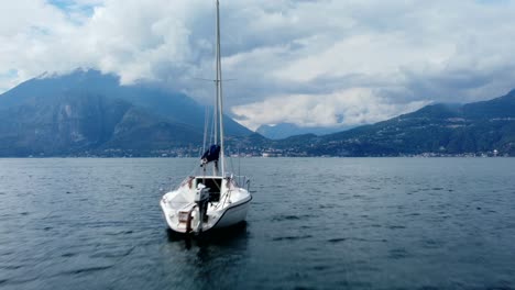 Insane-drone-shot-flying-past-boats-in-the-sea-with-dramatic-mountains