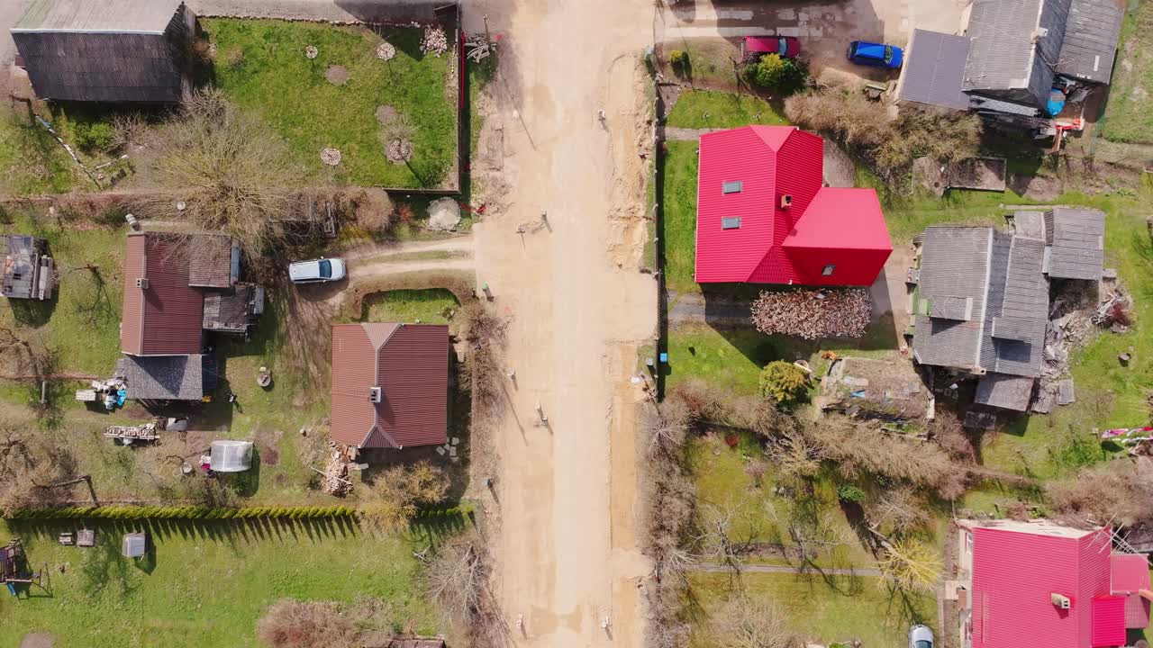 Overhead drone shot captures pre-paving phase in rural Latvian settlement