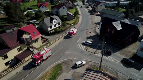 4k drone shot of fire trucks at the cross road in countryside on sunny day