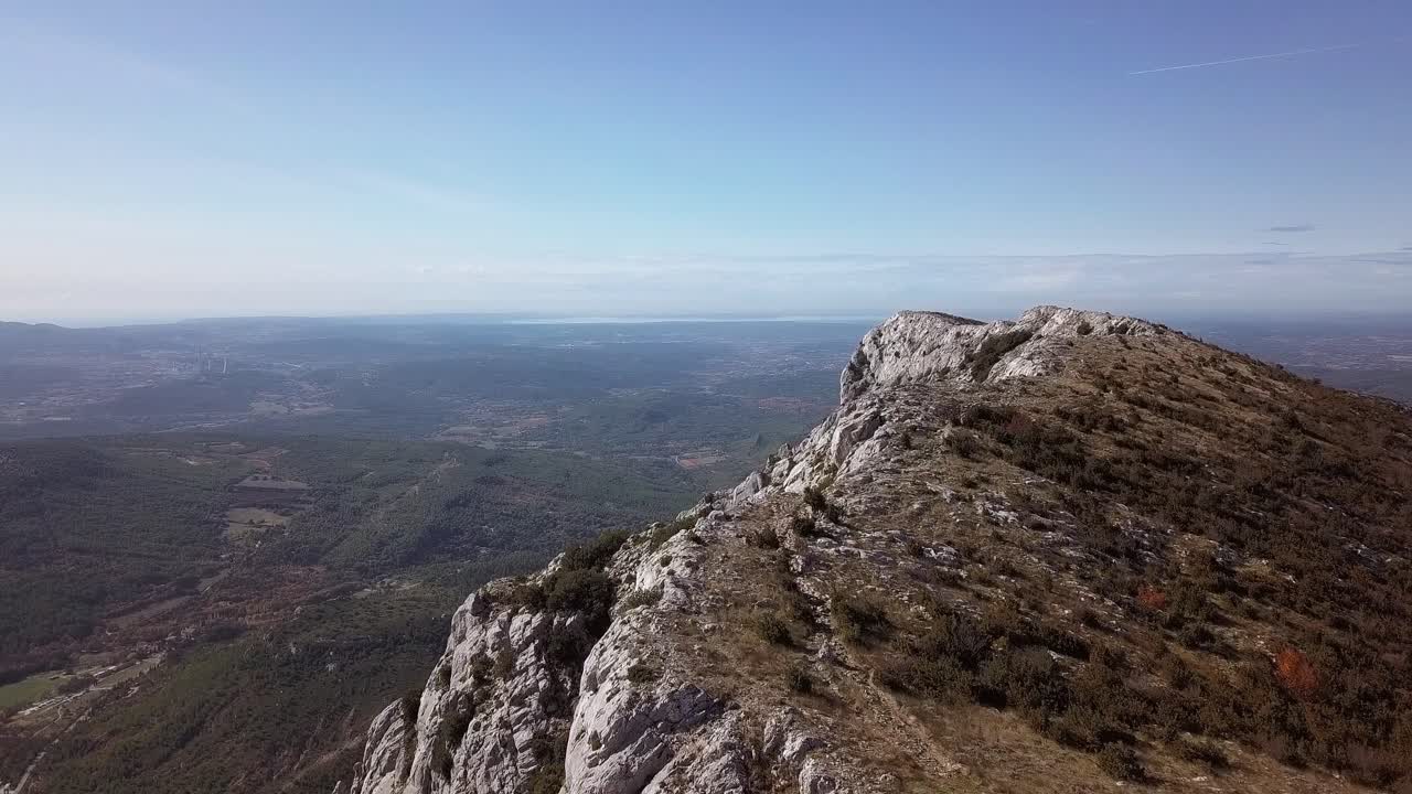 Flying close to a mountainous rocky outcrop high above St. Victoire, Aix en Provence, France, aerial