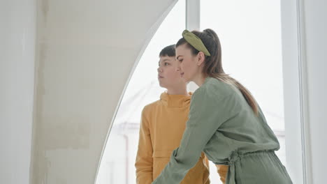 mother and son painting a wall