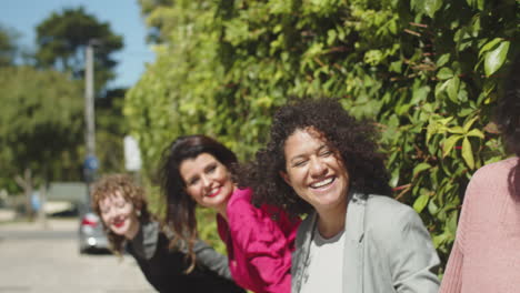 happy lesbian brides looking at their friends