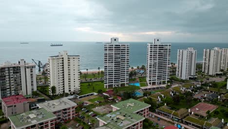 Bird's-eye-dolly-in-view-of-the-luxury-residential-buildings-overlooking-the-sea-in-ViÃ±a-del-Mar,-Chile