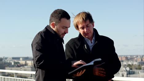 two business people walking and discussing outside the office