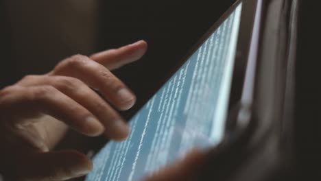 shooted in slow motion showing man's hands browsing social media or playing with a mobile tablet at evening