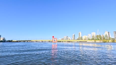 boat travels along river with city skyline