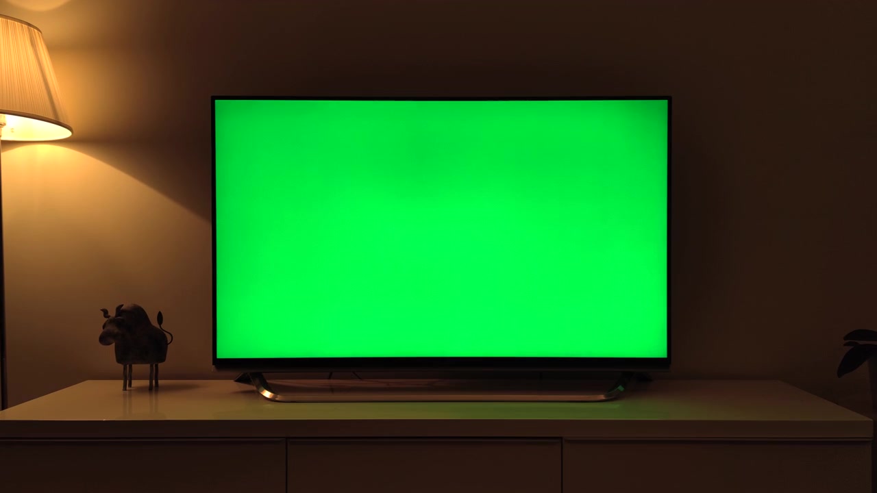 Television with Green Screen in Dimly Lit Living Room